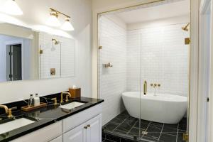 a bathroom with a tub and a sink at Hotel Burg in Leesburg +69 photos
