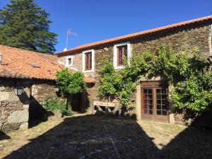 an external view of a stone house with a yard at Herdade Do Vale Coelheiro in Toulões