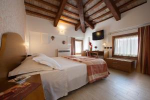 a bedroom with a large bed and a television at Albergo Antica Corte Marchesini in Campagna Lupia +82 photos
