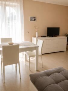 a living room with a white table and chairs at Casa vacanze "Ellen" - AAUT in Bianchi