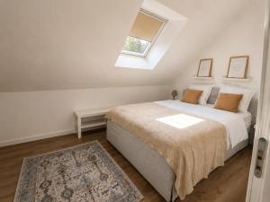 a bedroom with a large bed with a window at Appartement JM in Cherbourg en Cotentin