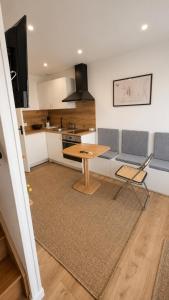 a kitchen and living room with a table and chairs at Appartement JM in Cherbourg en Cotentin