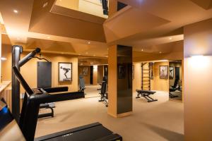 a gym with a elliptical trainer and treadmills at QC Room Milano Porta Romana in Milan