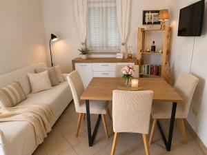 a living room with a table and a couch at Apartman David in Postira