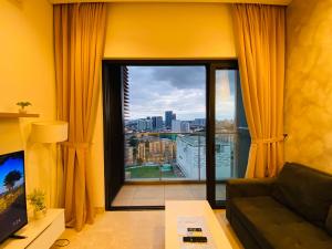 a living room with a large window with a view at Luxury Suites By Lucentia Residence BBCC Kuala Lumpur in Kuala Lumpur