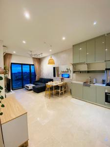 a kitchen and living room with a couch and a table at Luxury Suites By Lucentia Residence BBCC Kuala Lumpur in Kuala Lumpur