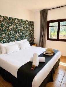 a bedroom with a large bed with towels on it at Primavera House Port Sóller formerly Sol Port Sóller in Port de Soller