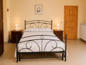 a bed in a bedroom with two night stands and two lamps at Casa vacanze "Ellen" - AAUT in Bianchi