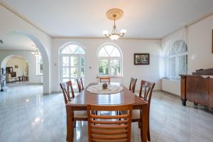 a dining room with a table and chairs at Villa Panorama in Biatorbágy +25 photos