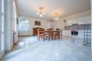 a kitchen and dining room with a table and chairs at Villa Panorama in Biatorbágy