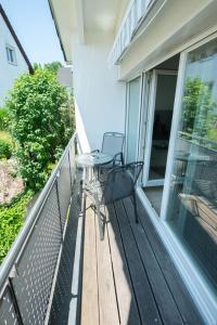 a balcony with a table and chairs on a porch at Am Bienenfeld in Ettenheim