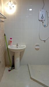 a bathroom with a sink and a shower at DKajang Villa Homestay Kajang in Kajang