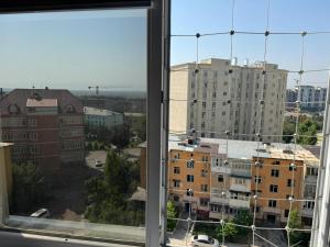 a view of a city from a window at Luxury Residence by HomeLand in Khujand