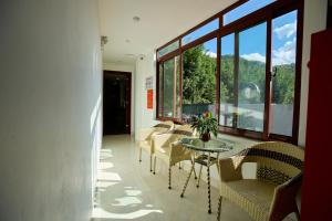 a room with a table and chairs and windows at Harmony Haven Hotel in Sapa