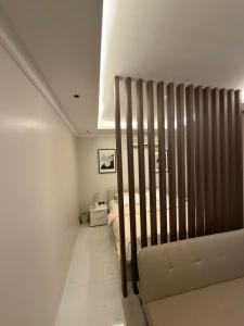 ein weißes Zimmer mit einem Bett und einer Couch in der Unterkunft Sar studio in Khobar
