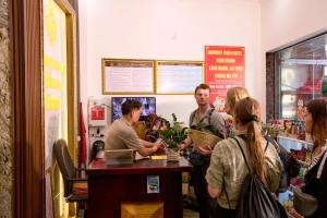 a group of people standing around a counter in a store at Harmony Haven Hotel in Sapa