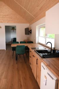 a kitchen and dining room with a table and chairs at Nad Doliną Krutyni in Ukta