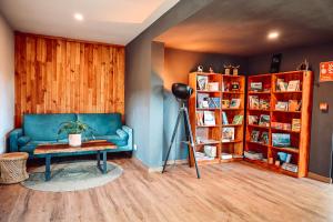 a living room with a blue couch and a table at OBOĒ Gardenstē in Pereybere