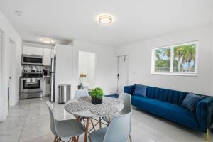 a living room with a blue couch and a table and chairs at 11430 Lincoln Blvd in Richmond Heights