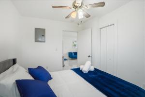 a bedroom with a bed with blue pillows and a ceiling fan at 11430 Lincoln Blvd in Richmond Heights