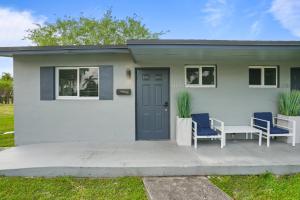 a small white house with two chairs and a table at 11430 Lincoln Blvd in Richmond Heights