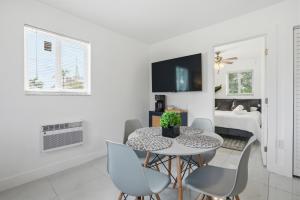 a white dining room with a table and chairs at 11430 Lincoln Blvd in Richmond Heights +6 photos
