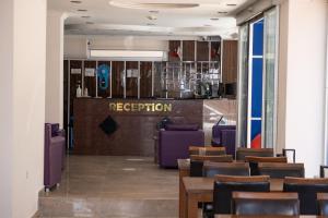 a restaurant with purple chairs and a bar at Seymen Otel in Kizkalesi