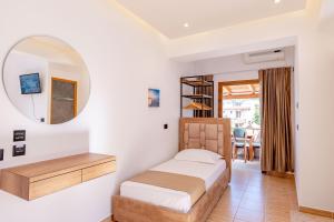 a bedroom with a bed and a mirror at Hotel ENAD in Ksamil +69 photos
