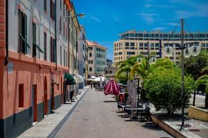 a city street with chairs and tables and buildings at Historic Hub - Crociere a 10 min - AC - WiFi Gratis in Savona