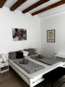 a bedroom with two beds and a table at White House Apartments in Korčula