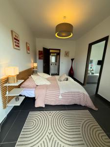 a large bedroom with two beds and a rug at Casa Avvena 2 in Lecci