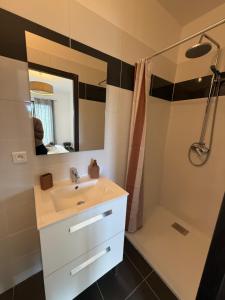 a bathroom with a sink and a shower at Casa Avvena 2 in Lecci