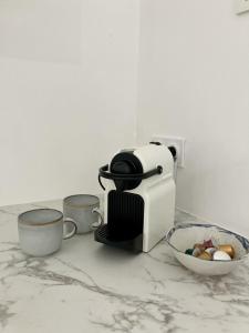 a coffee maker and a bowl of food on a counter at Balcon sur les vignes - Loft de charme 2 pers in Cournanel +9 photos