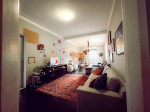 a living room with a couch and a tv at Hostel Triplo J e Guest House in Salvador