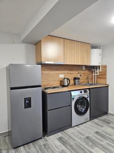a kitchen with a refrigerator and a washing machine at Amatuni Guest House in Stepʼanavan