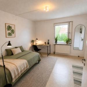 a bedroom with a bed and a desk and a window at Klintehamn Rooms - Near the Sea in Klintehamn
