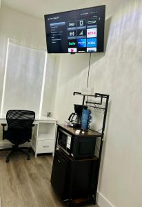 a room with a desk and a chair and a television at The Sunshine Studio - No Smoking in Orlando +10 photos
