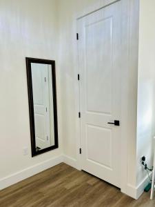 a white door with a mirror in a room at The Sunshine Studio - No Smoking in Orlando