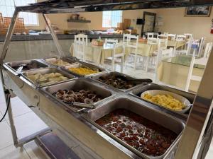 a buffet line with many different types of food at Pousada Sol Nascente in Piranhas