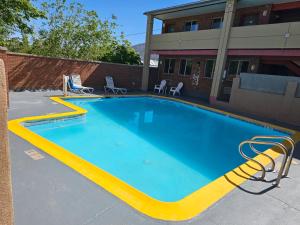 a large swimming pool in front of a building at Cedar Valley Inn in Cedar City