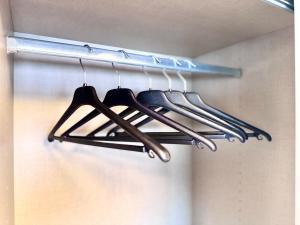 a bunch of utensils are hanging on a rack at Ferienwohnung Artemis in Eggingen +8 photos