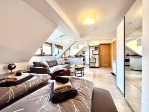 a living room with two beds and a couch at Ferienwohnung Artemis in Eggingen