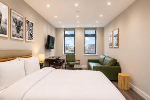a hotel room with a bed and a living room at The Orpington View in Orpington +3 photos