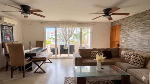 a living room with a couch and a table at La Marina Condominiums by Monyxbnb in Puerto Vallarta