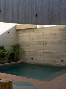a swimming pool with a wooden wall at Design-Forward 2BR Villa with Private Pool NEW in Brisas de Zicatela