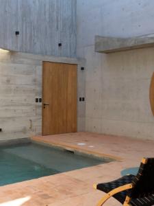 a swimming pool with a wooden door in a room at Design-Forward 2BR Villa with Private Pool NEW in Brisas de Zicatela +54 photos