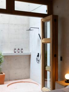a bathroom with a shower with a glass door at Design-Forward 2BR Villa with Private Pool NEW in Brisas de Zicatela