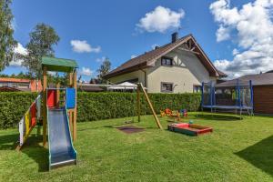 a yard with playground equipment on the grass at Guest House Pasaulio Krastas in Palanga