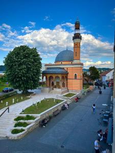 a building with a clock tower on top of it at Golden Nest in Tuzla