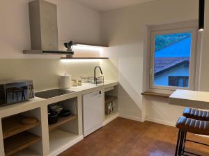 a kitchen with a sink and a window at Casa Nina in Valbravenna